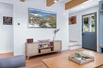a living room with white walls and a blue door at Majestic Lakeview Lodge in Lake Arrowhead