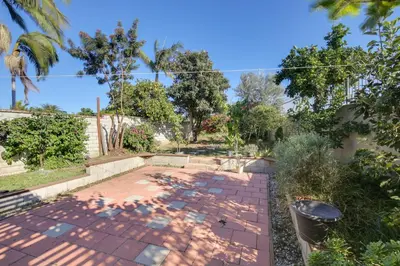 a garden with a brick patio and trees at Lakewood Home about 5 Mi to Knotts Berry Farm! in Lakewood