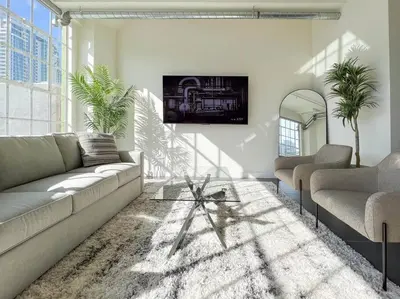 a living room with a couch and two chairs at Modern Loft in DTLA - Rooftop Pool & Free Parking! in Los Angeles