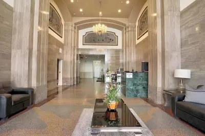 a lobby with couches and a table in a building at Modern Loft in DTLA - Rooftop Pool & Free Parking! in Los Angeles
