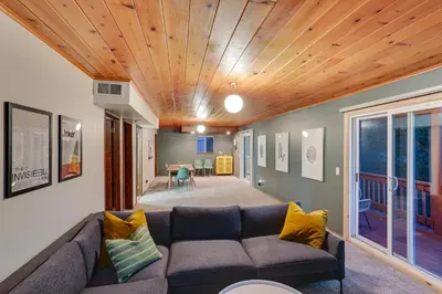 a living room with a couch and a wooden ceiling at Crestline Cabin Mountain Views and Fire Pit! in Crestline