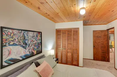 a living room with a couch and a large painting on the wall at Crestline Cabin Mountain Views and Fire Pit! in Crestline