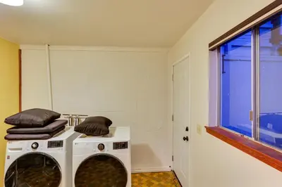two washing machines in a room with a window at Crestline Cabin Mountain Views and Fire Pit! in Crestline