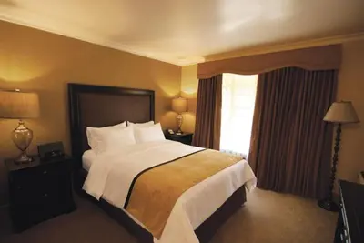a hotel room with a large bed and a window at The Inn at UCLA in Los Angeles