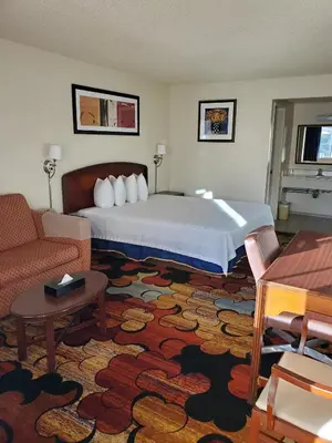 a hotel room with a bed and a couch at Eunice Plaza Motel in El Monte