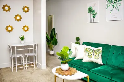 a living room with a green couch and a table at MDR Studio Apartment Luxury pool, gym, parking, jacuzzi. in Los Angeles