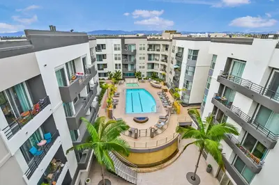 an overhead view of an apartment complex with a pool and palm trees at MDR Studio Apartment Luxury pool, gym, parking, jacuzzi. in Los Angeles