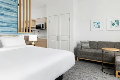 a hotel room with a bed and a couch at TownePlace Suites by Marriott Monrovia in Monrovia