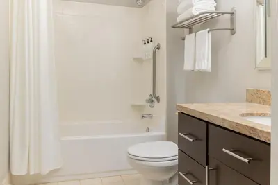 a bathroom with a toilet and a shower and a sink at TownePlace Suites by Marriott Monrovia in Monrovia