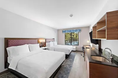 a hotel room with two beds and a kitchen at Hampton Inn Big Bear Lake in Big Bear Lake