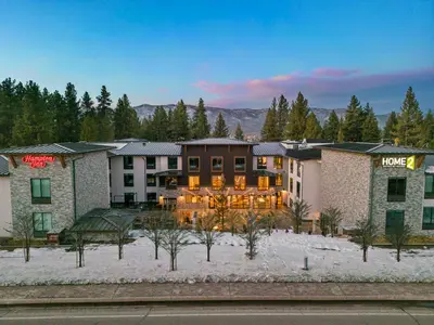 a hotel in the middle of a snow covered yard at Home2 Suites By Hilton Big Bear Lake in Big Bear Lake