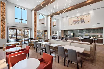 a restaurant with tables and chairs and a bar at Home2 Suites By Hilton Big Bear Lake in Big Bear Lake
