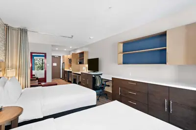 a hotel room with two beds and a desk at Home2 Suites By Hilton Big Bear Lake in Big Bear Lake