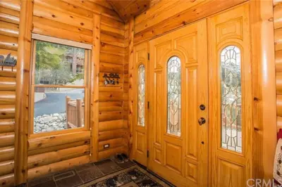 a log cabin with a door and windows at Peaceful Cabin Home with Breathtaking View! in Big Bear City