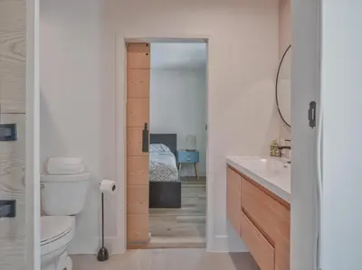 a bathroom with a toilet and a sink and a mirror at Hollywood Dream pool home & king beds in Los Angeles