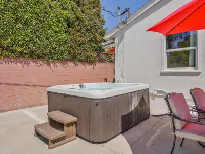 a wooden bath tub sitting next to a table and chairs at Hollywood Dream pool home & king beds in Los Angeles