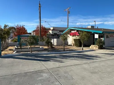 an empty parking lot in front of a store at Sherwood Motel in Palmdale