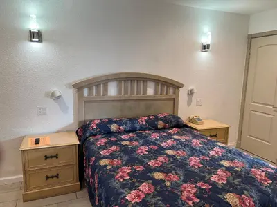 a bedroom with a bed and two night stands at Sherwood Motel in Palmdale