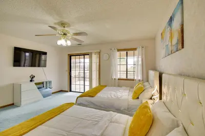 a bedroom with two beds and a couch at Spacious California Oasis Patio, Fireplace and Pool in Apple Valley