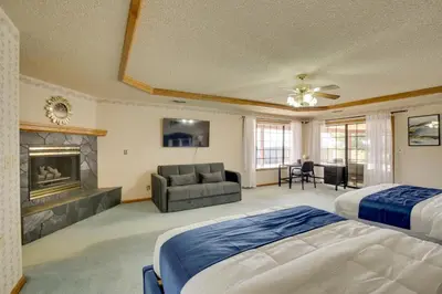 a large bedroom with two beds and a fireplace at Spacious California Oasis Patio, Fireplace and Pool in Apple Valley