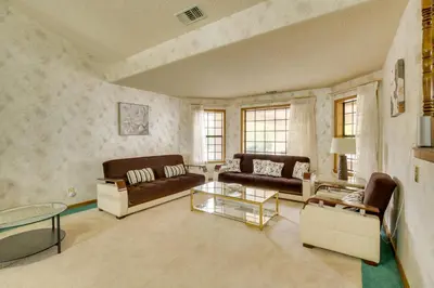 a living room with two couches and a table at Spacious California Oasis Patio, Fireplace and Pool in Apple Valley