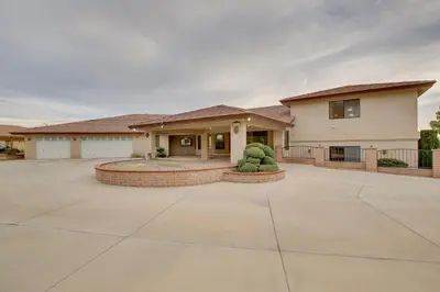a large house with a large driveway at Spacious California Oasis Patio, Fireplace and Pool in Apple Valley