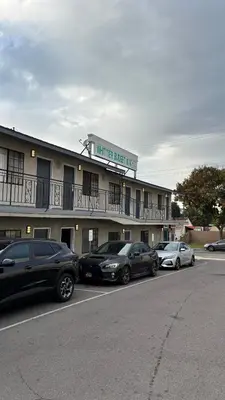 a hotel with cars parked in a parking lot at Budget inn Whittier in Whittier
