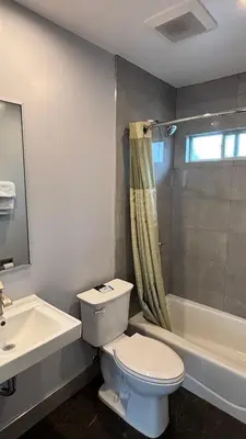 a bathroom with a toilet and a sink and a shower at Budget inn Whittier in Whittier