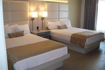 a hotel room with two beds and two lamps at Ramada by Wyndham Burbank Airport in Burbank