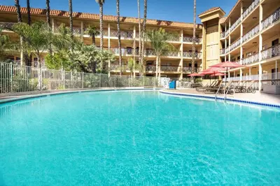 a large swimming pool in front of a building at Ramada by Wyndham Burbank Airport in Burbank