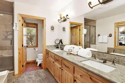 a bathroom with two sinks and a large mirror at Gold Rush Lodge Big Bear~Hot Tub~ Games~ in Big Bear Lake