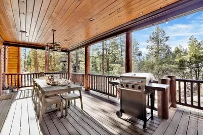 a screened in porch with a grill on a deck at Gold Rush Lodge Big Bear~Hot Tub~ Games~ in Big Bear Lake