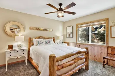 a bedroom with a bed and a ceiling fan at Gold Rush Lodge Big Bear~Hot Tub~ Games~ in Big Bear Lake