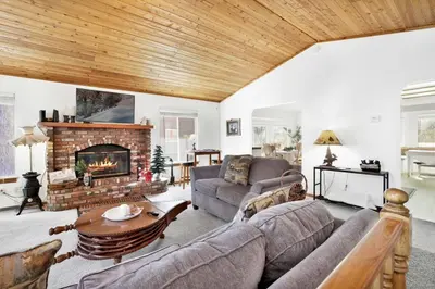 a living room with a couch and a fireplace at Divine Chateau Big Bear~ Hot Tub~ Walk to Lake~ in Big Bear Lake