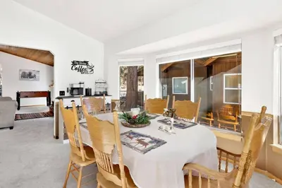 a dining room with a table and chairs at Divine Chateau Big Bear~ Hot Tub~ Walk to Lake~ in Big Bear Lake