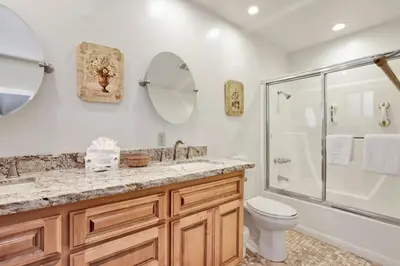 a bathroom with a shower and a toilet and a sink at A Hidden Asset Big Bear~ Hot Tub~ Walk to Village~ in Big Bear Lake