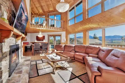 a living room with a couch and a fireplace at The Octagon Big Bear~ Hot Tub~ Pool Table~Views in Big Bear City