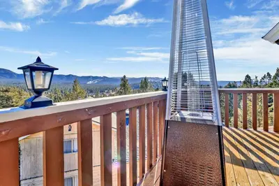 a balcony with a view of a building at The Octagon Big Bear~ Hot Tub~ Pool Table~Views in Big Bear City