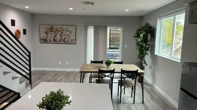 a kitchen and dining room with a table and chairs at Normandie Hostel in Los Angeles