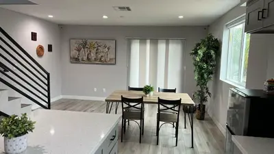 a kitchen and dining room with a table and chairs at Normandie Hostel in Los Angeles