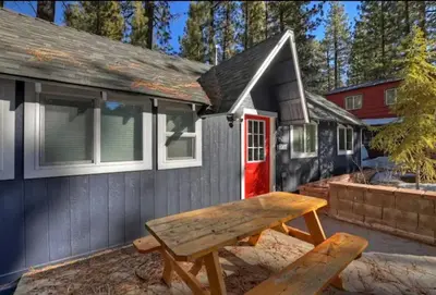 a picnic table in front of a tiny house at Modern Moab: Near Boulder Bay + Spa + Large Yard in Big Bear Lake