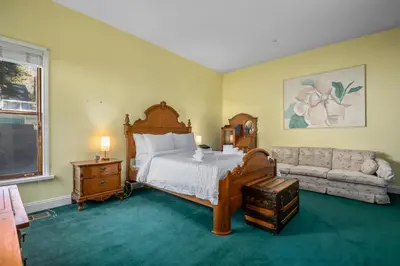 a bedroom with a bed and a couch at Mountain High Luxury Castle &Spa in Wrightwood