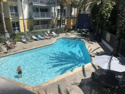 a woman in a swimming pool at a hotel at The Moonstone - Cozy Marina side Garden View Pool and Gym in Los Angeles