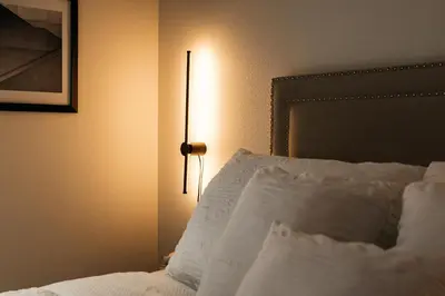 a bedroom with a bed with a lamp next to it at Elegant Apartment in the Heart of Hollywood in Los Angeles