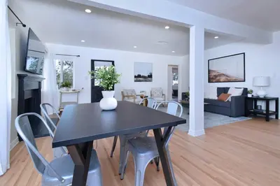 a dining room and living room with a table and chairs at Beautiful 3 Bed Home with a Large Back Yard Outdoor Space in Los Angeles