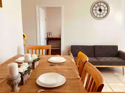 a dining room with a table and a couch at Charming 3BR Retreat near Disneyland Downtown LA! in Rowland Heights