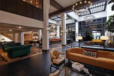 a lobby of a hotel with couches and chairs at Hotel Figueroa, Unbound Collection by Hyatt in Los Angeles
