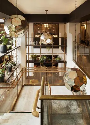 a room with two tables and potted plants in it at Hotel Figueroa, Unbound Collection by Hyatt in Los Angeles