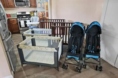 two baby strollers are sitting in a kitchen at The Disneyland Dream by OC Adventure Homes in Garden Grove