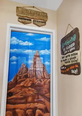 a picture of a mountain on a wall with signs at The Disneyland Dream by OC Adventure Homes in Garden Grove